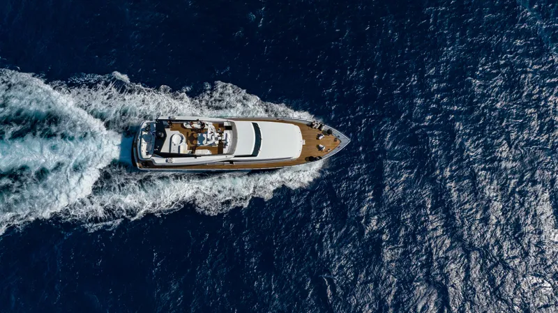 Bellini Yacht Photos Pics Aerial view of 1988 Cantieri di Pisa AKHIR 30 yacht cruising on open sea.