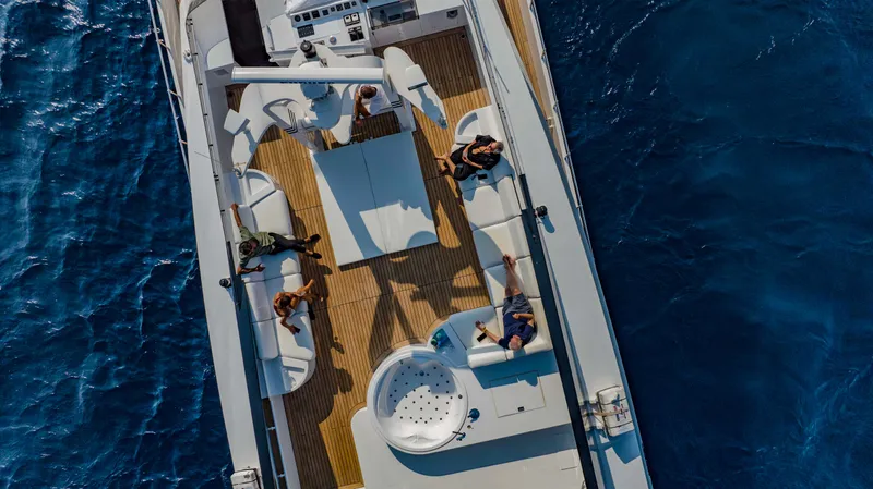 Bellini Yacht Photos Pics Aerial view of 1988 Cantieri di Pisa AKHIR 30 yacht on blue ocean waters.