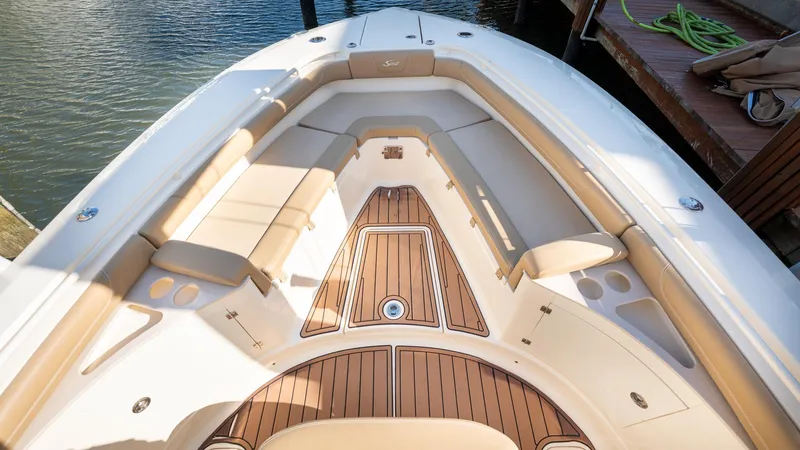  Yacht Photos Pics 2019 Scout 275 LXF boat interior with cushioned seating and teak flooring.