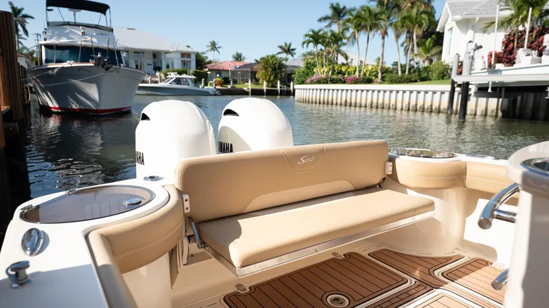  Yacht Photos Pics 2019 Scout 275 LXF boat docked in sunny marina with palm trees.