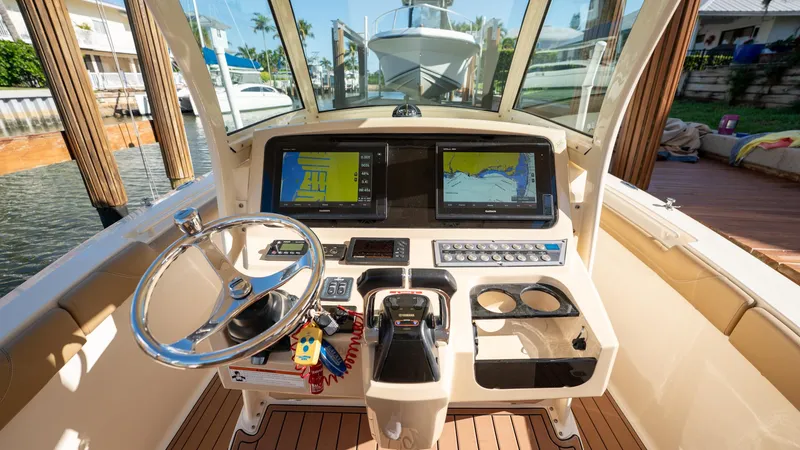  Yacht Photos Pics 2019 Scout 275 LXF boat helm with dual navigation screens and steering wheel.
