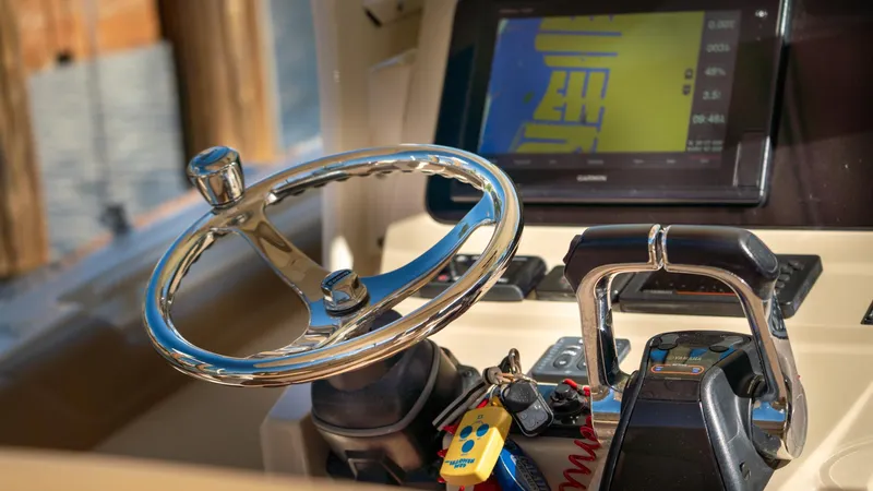  Yacht Photos Pics Steering wheel and controls of a 2019 Scout 275 LXF boat.