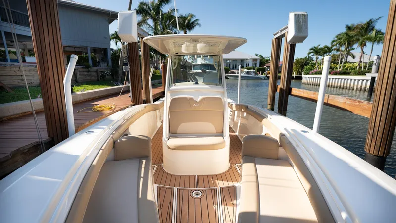  Yacht Photos Pics 2019 Scout 275 LXF boat with elegant seating and teak flooring at a dock.