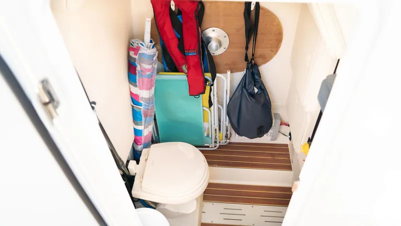  Yacht Photos Pics 2019 Scout 275 LXF boat interior with storage, toilet, and beach gear.
