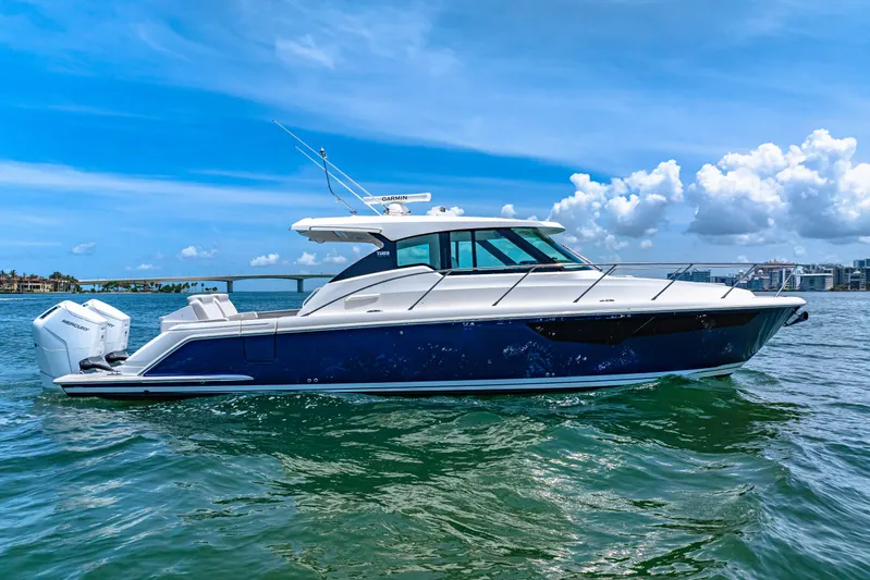  Yacht Photos Pics 2022 Tiara Yachts 43 LE cruising on a sunny day with clear blue skies.
