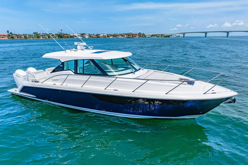  Yacht Photos Pics 2022 Tiara Yachts 43 LE cruising on clear blue waters under a sunny sky.