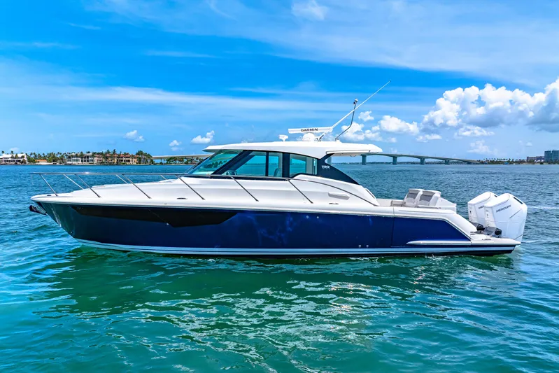  Yacht Photos Pics 2022 Tiara Yachts 43 LE cruising on a sunny day with clear blue skies.