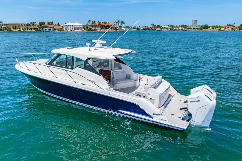  Yacht Photos Pics 2022 Tiara Yachts 43 LE cruising on clear blue water, showcasing sleek design and powerful engines.