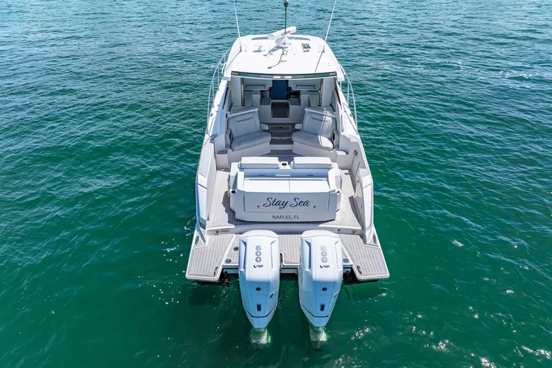  Yacht Photos Pics 2022 Tiara Yachts 43 LE on water, rear view with twin engines, luxury seating.