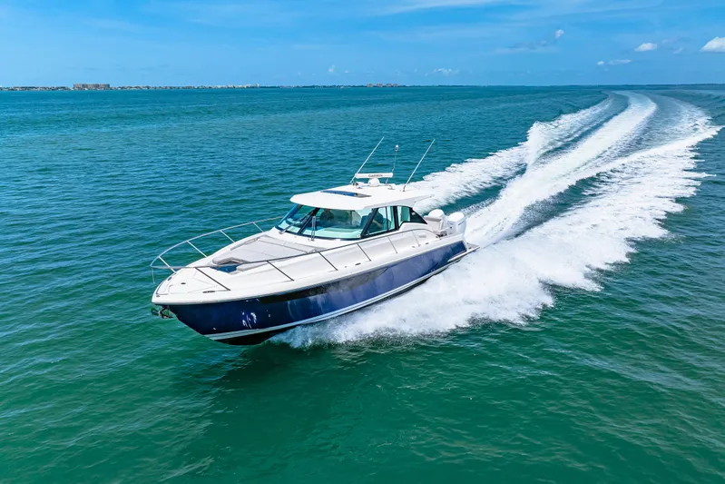  Yacht Photos Pics 2022 Tiara Yachts 43 LE cruising on open water under clear blue skies.