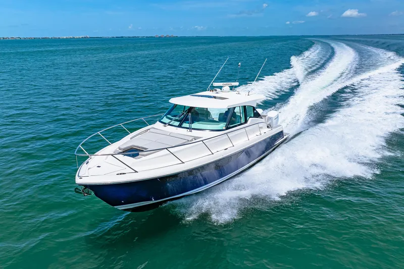  Yacht Photos Pics 2022 Tiara Yachts 43 LE cruising on open water, leaving a wake behind.