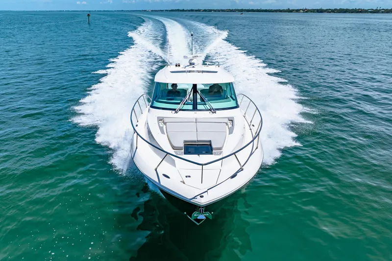  Yacht Photos Pics 2022 Tiara Yachts 43 LE cruising on open water, creating a dynamic wake.
