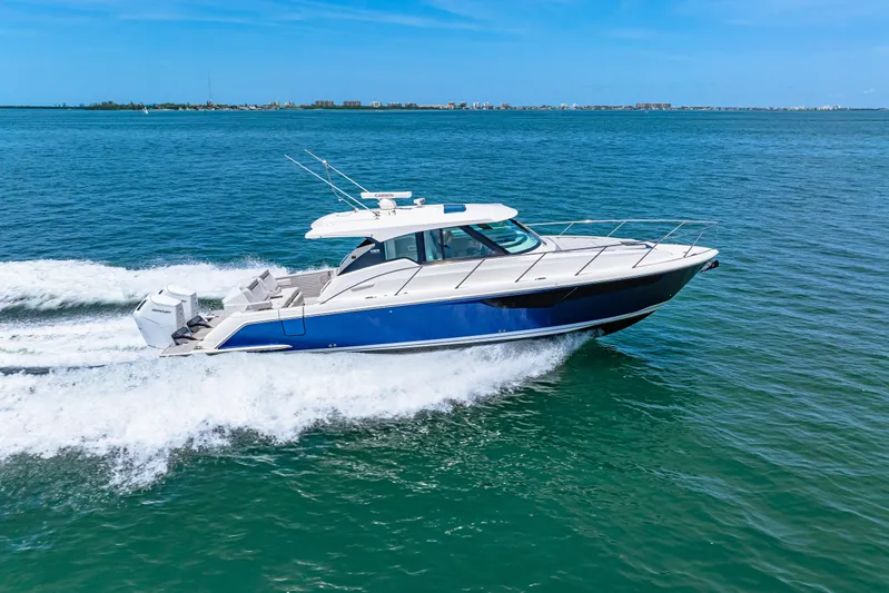 Yacht Photos Pics 2022 Tiara Yachts 43 LE cruising on open water under clear blue skies.