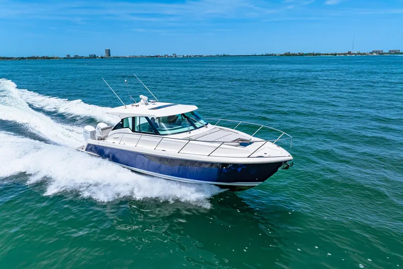  Yacht Photos Pics 2022 Tiara Yachts 43 LE cruising on open water under clear blue skies.