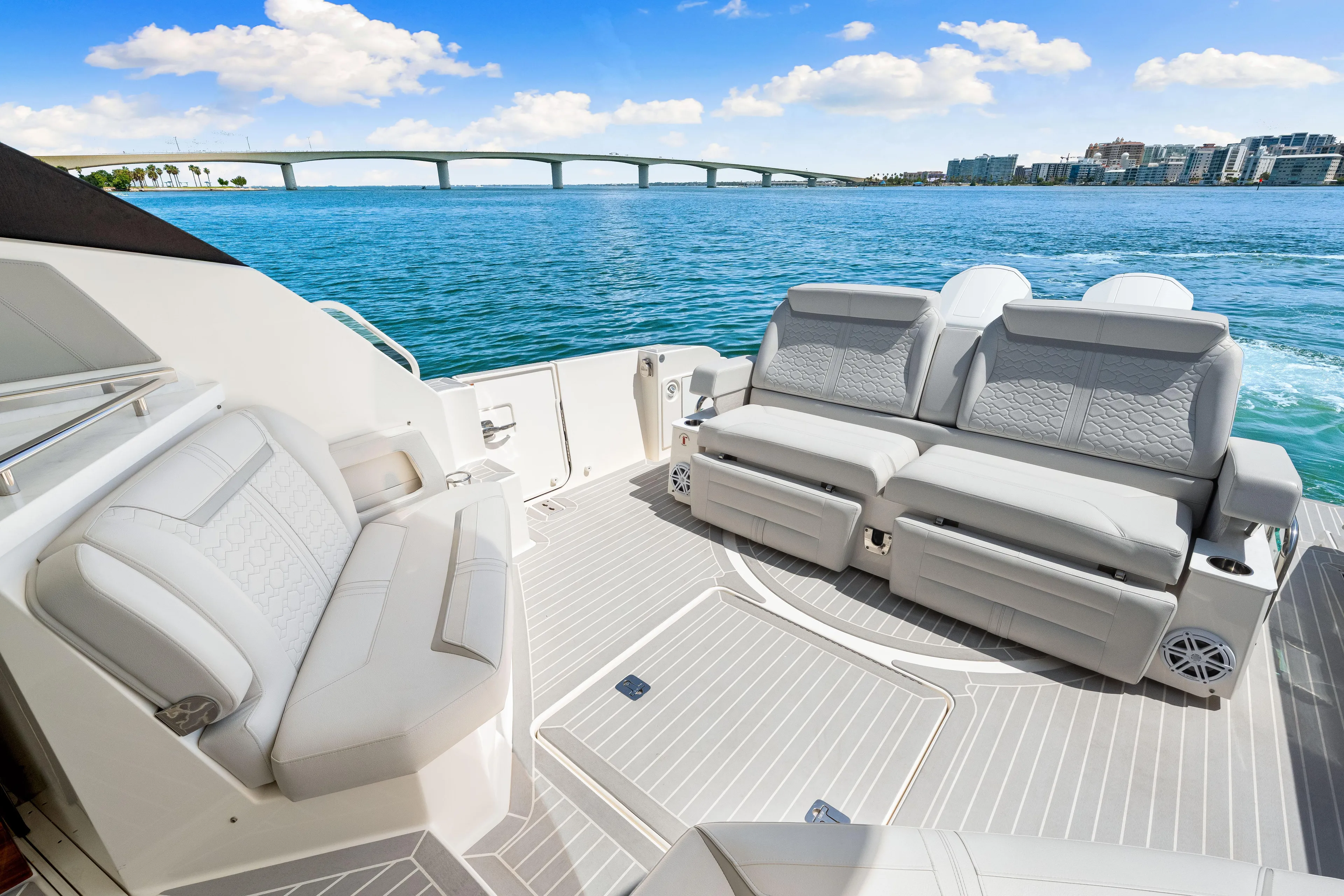  Yacht Photos Pics 2022 Tiara Yachts 43 LE luxury seating area with ocean view and bridge in background.