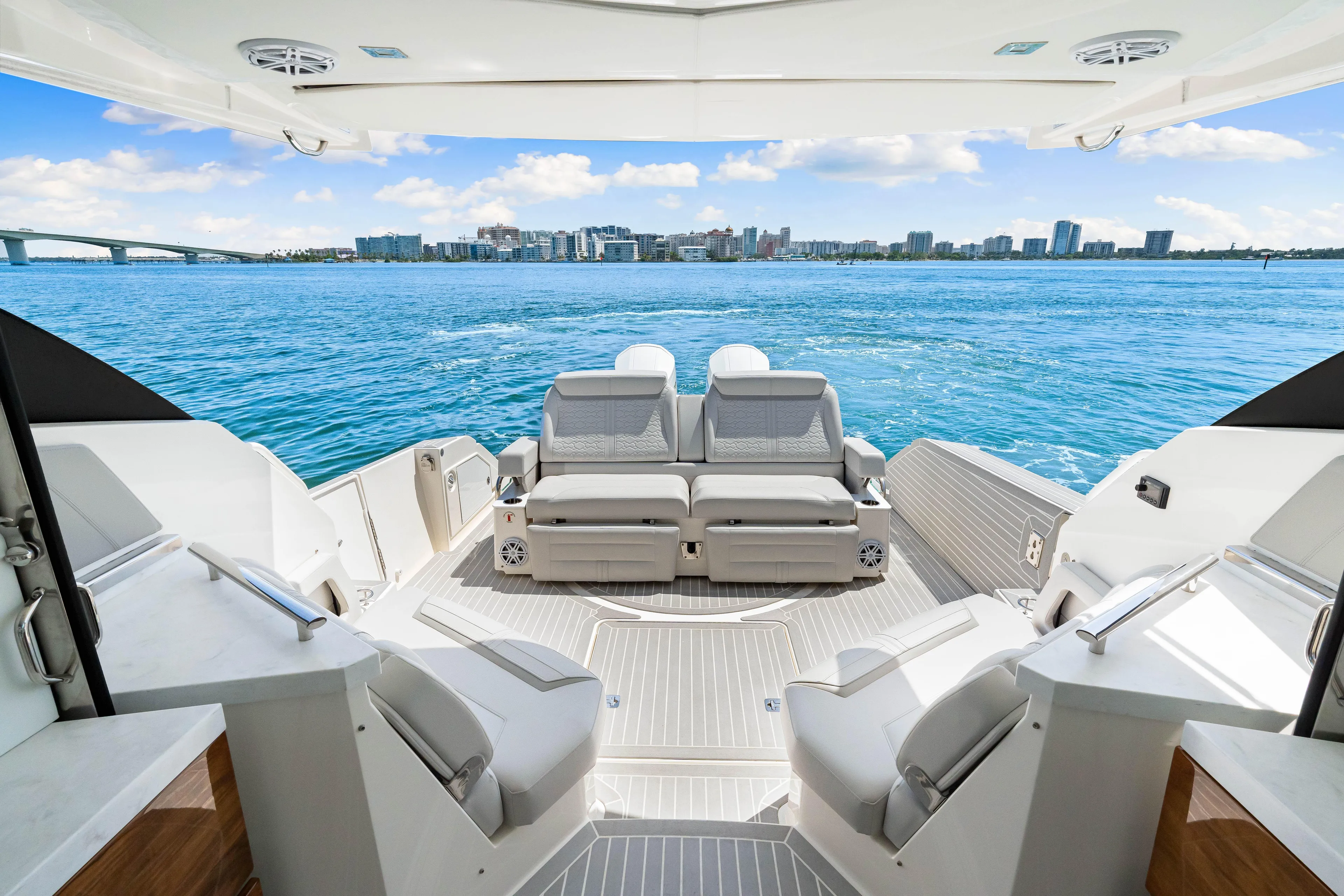  Yacht Photos Pics 2022 Tiara Yachts 43 LE luxury deck with ocean view and city skyline.
