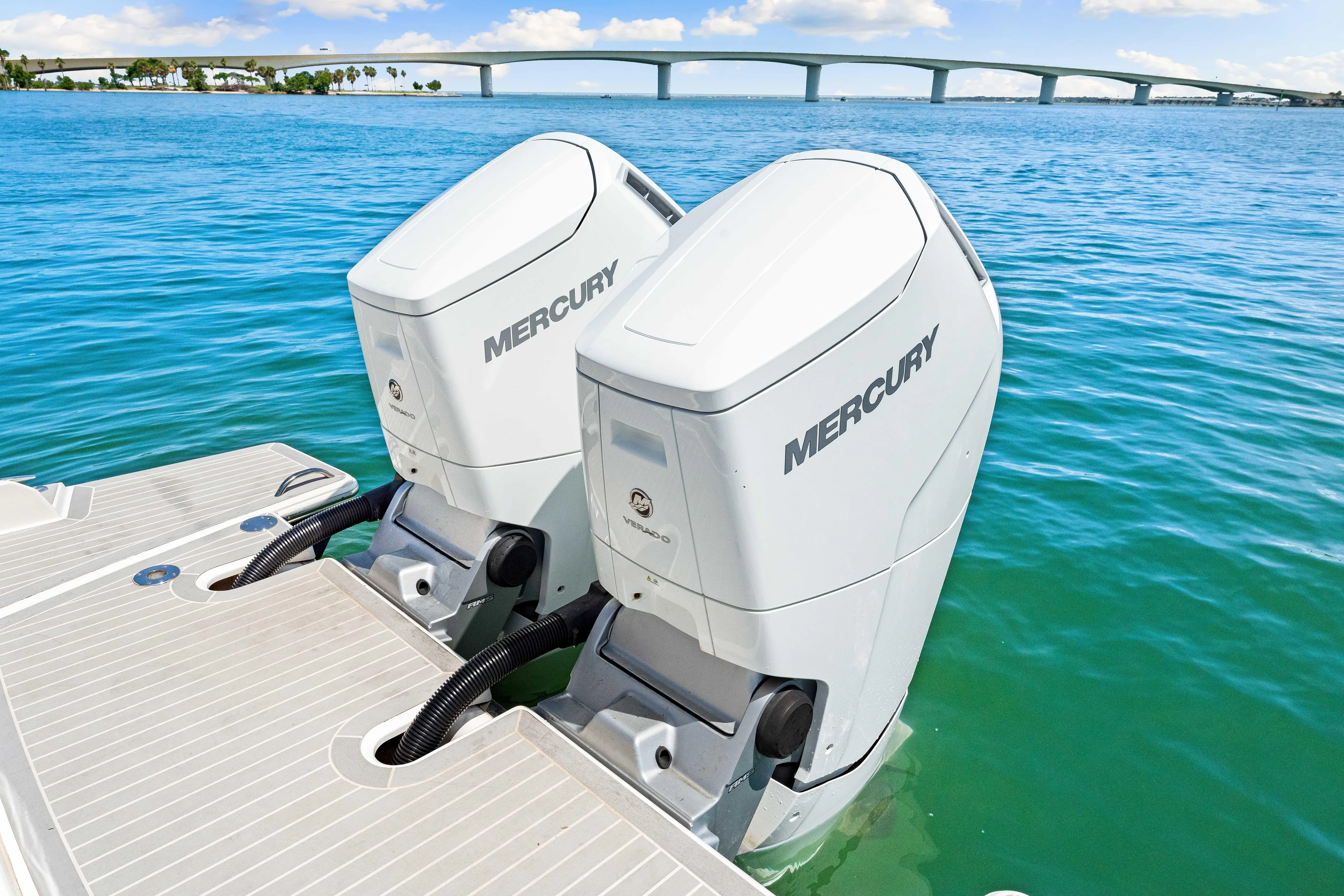  Yacht Photos Pics Twin Mercury outboard engines on a 2022 Tiara Yachts 43 LE, with a scenic bridge view.