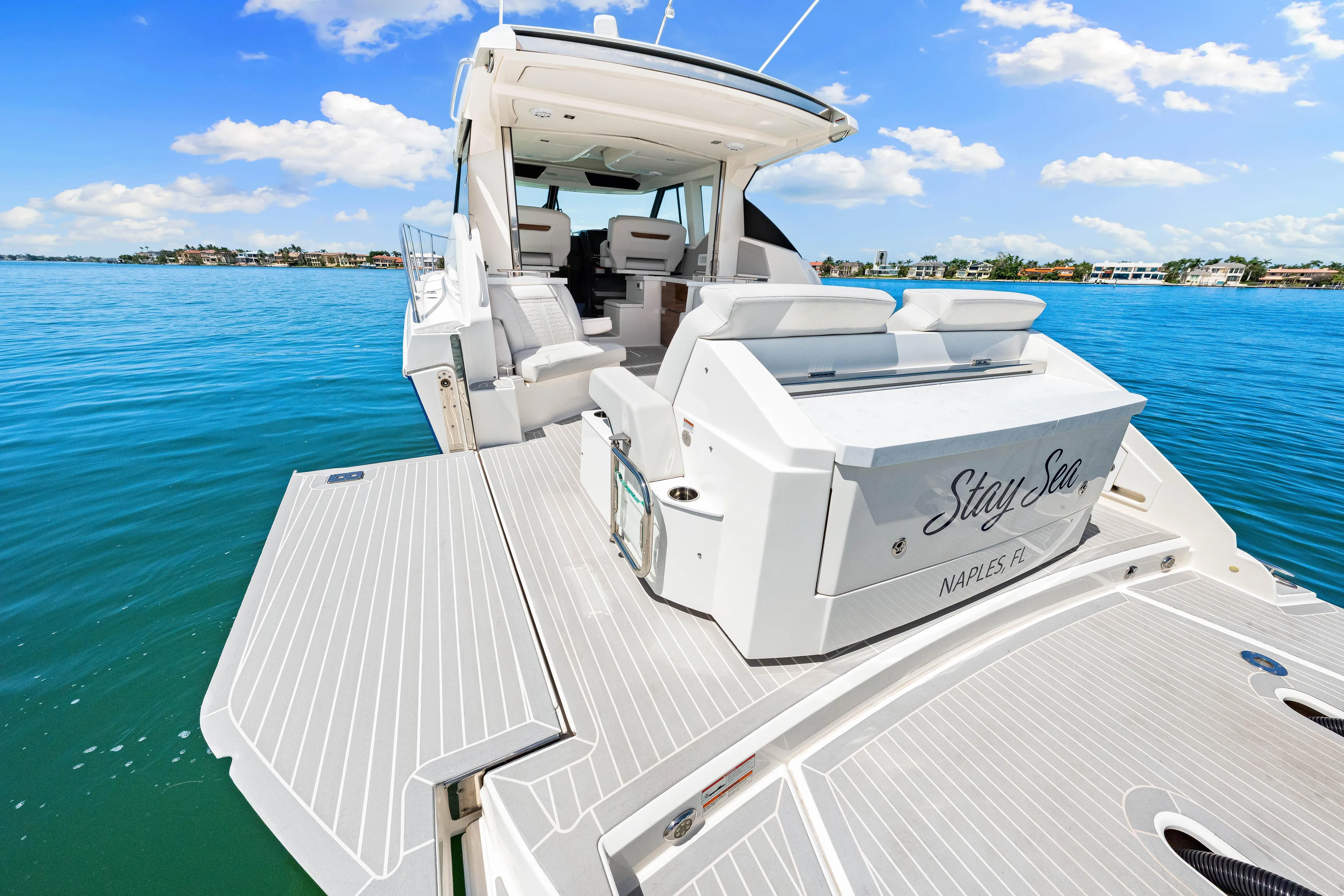  Yacht Photos Pics 2022 Tiara Yachts 43 LE on serene water, featuring spacious deck and luxurious seating.