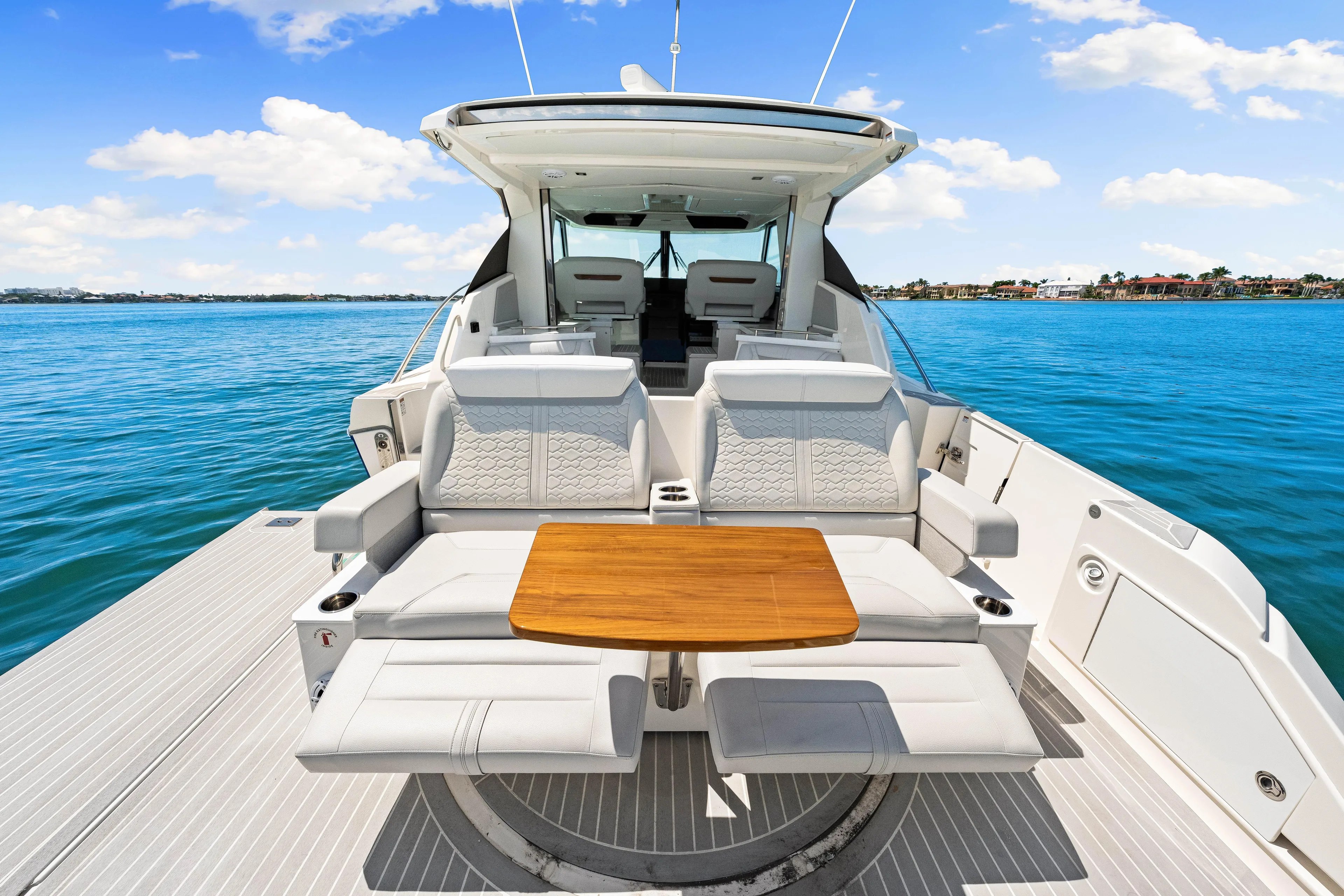  Yacht Photos Pics 2022 Tiara Yachts 43 LE luxury boat interior with seating and table on open water.