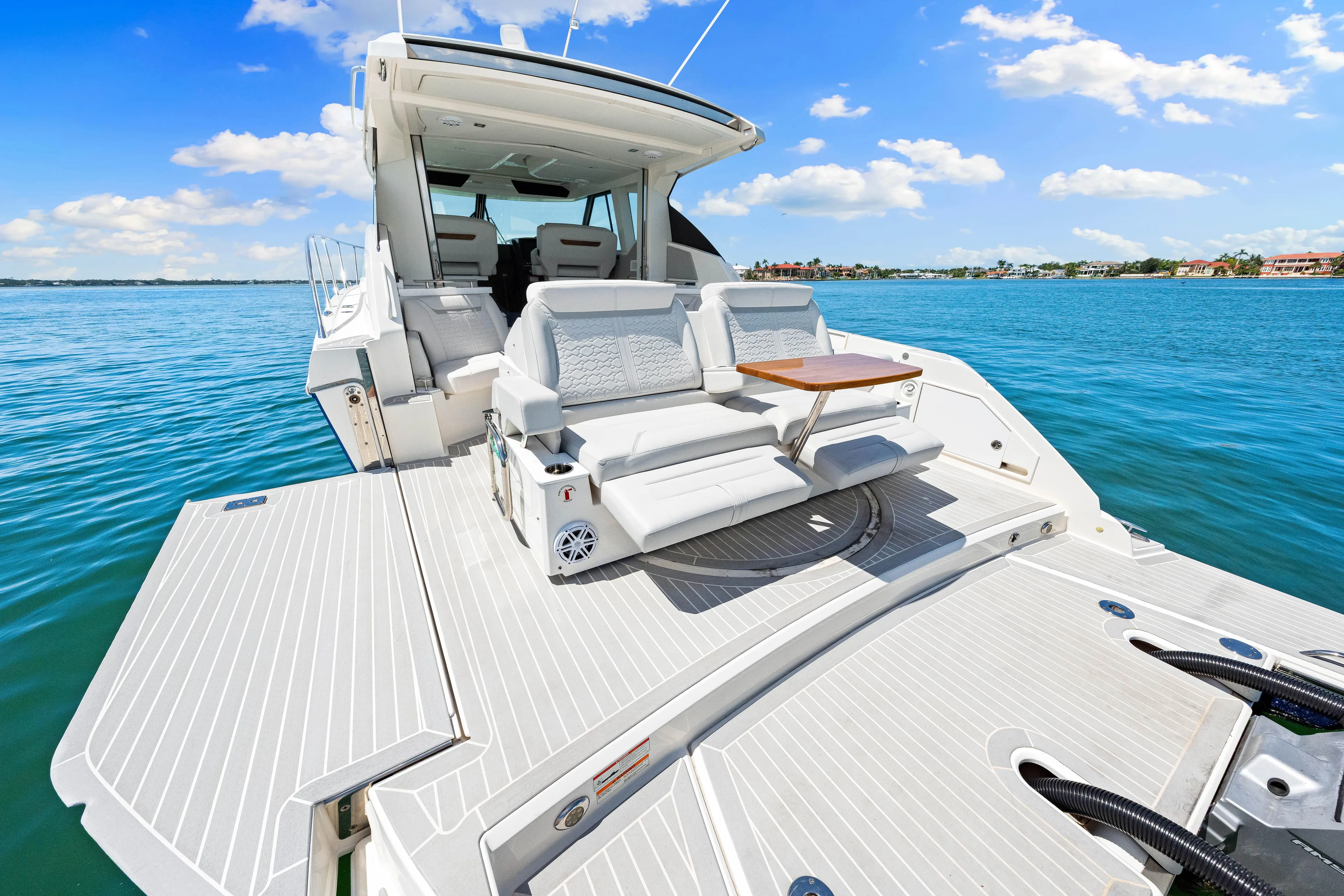  Yacht Photos Pics 2022 Tiara Yachts 43 LE luxury boat with spacious deck and seating on clear blue water.