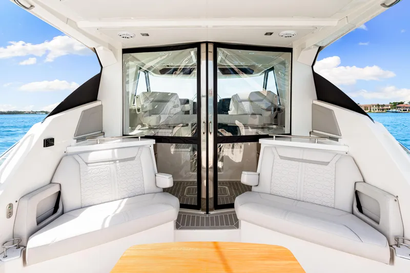  Yacht Photos Pics Luxurious 2022 Tiara Yachts 43 LE interior with plush seating and scenic ocean view.