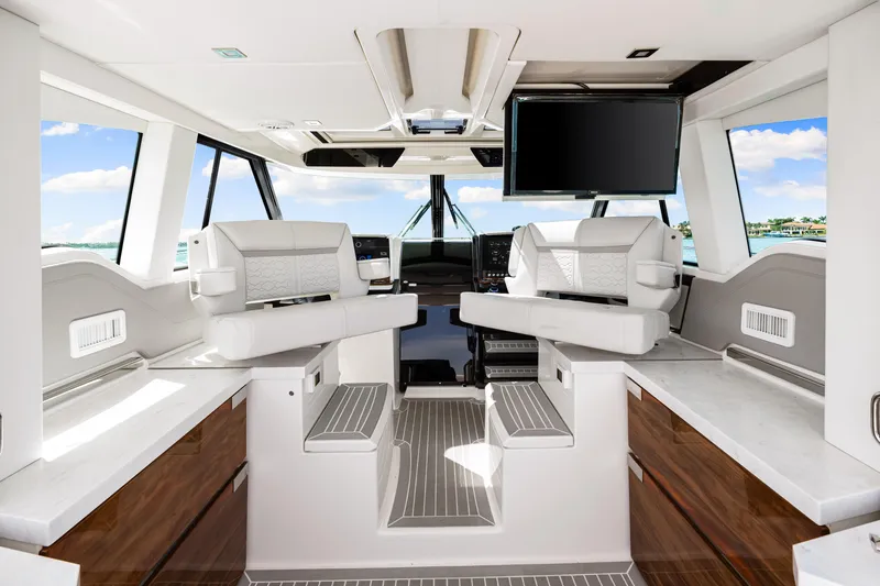  Yacht Photos Pics Luxurious interior of 2022 Tiara Yachts 43 LE with modern seating and panoramic windows.