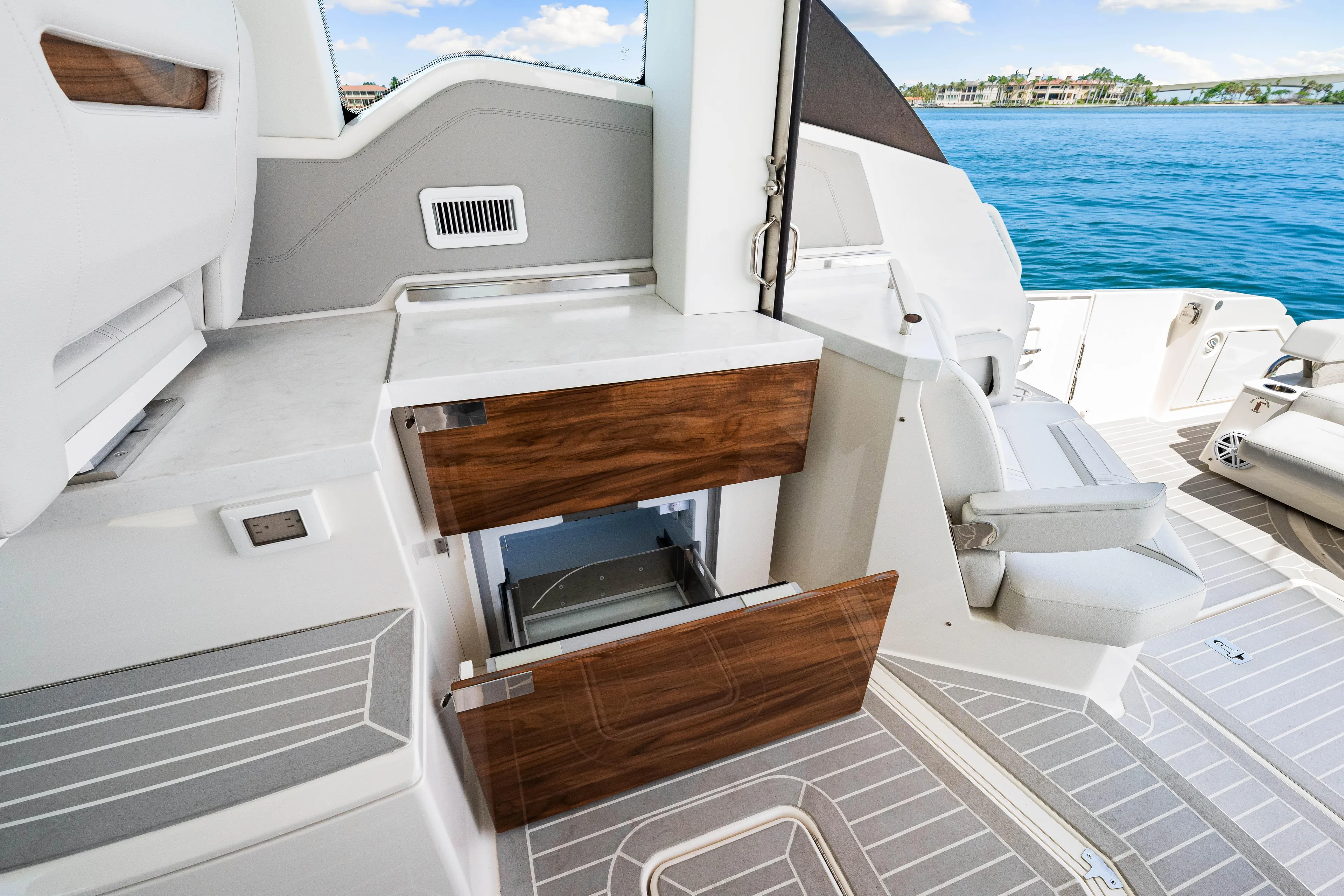  Yacht Photos Pics Interior of 2022 Tiara Yachts 43 LE, featuring sleek cabinetry and luxurious seating by the ocean.