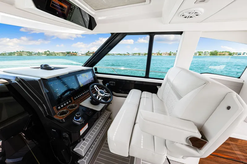  Yacht Photos Pics 2022 Tiara Yachts 43 LE helm with modern controls and luxurious seating, overlooking serene waters.
