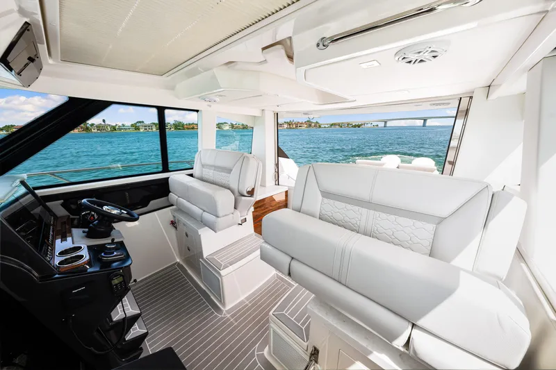  Yacht Photos Pics Interior of 2022 Tiara Yachts 43 LE, featuring luxurious seating and helm, overlooking the ocean.