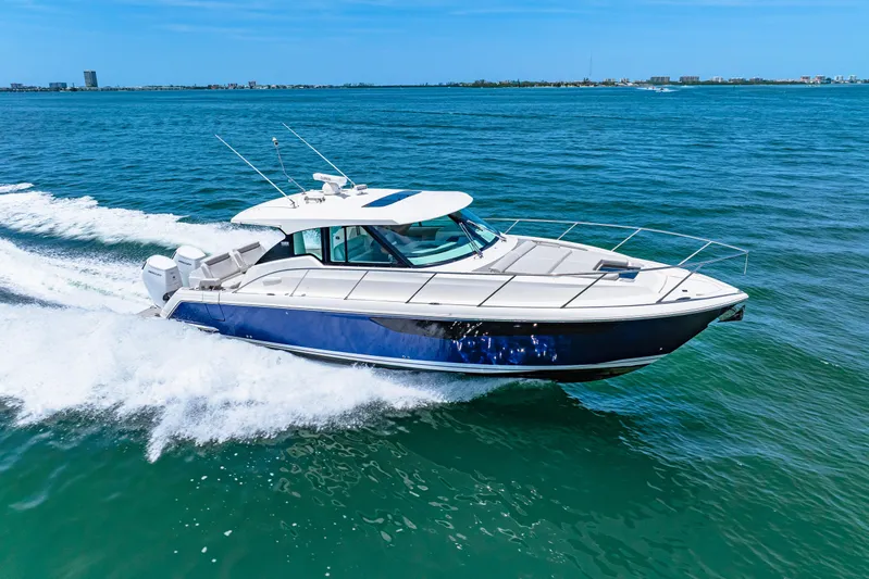  Yacht Photos Pics 2022 Tiara Yachts 43 LE cruising on open water under clear blue skies.