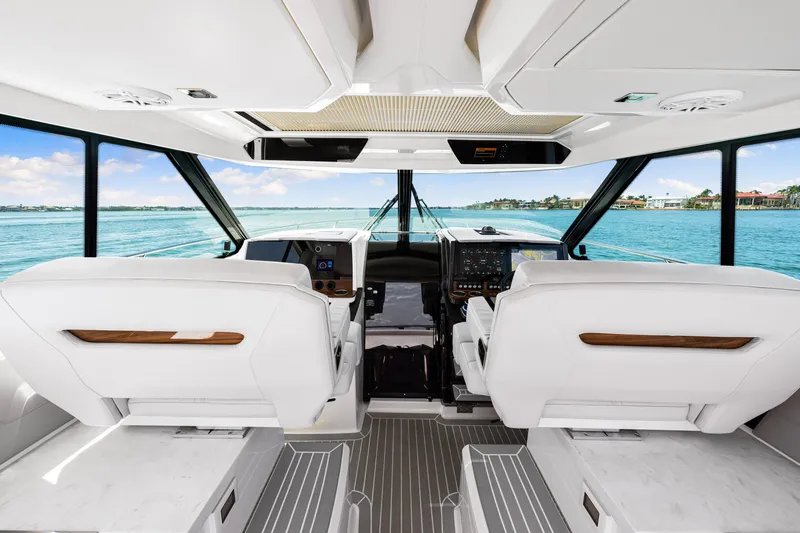  Yacht Photos Pics Interior view of 2022 Tiara Yachts 43 LE, featuring modern helm and luxurious seating.