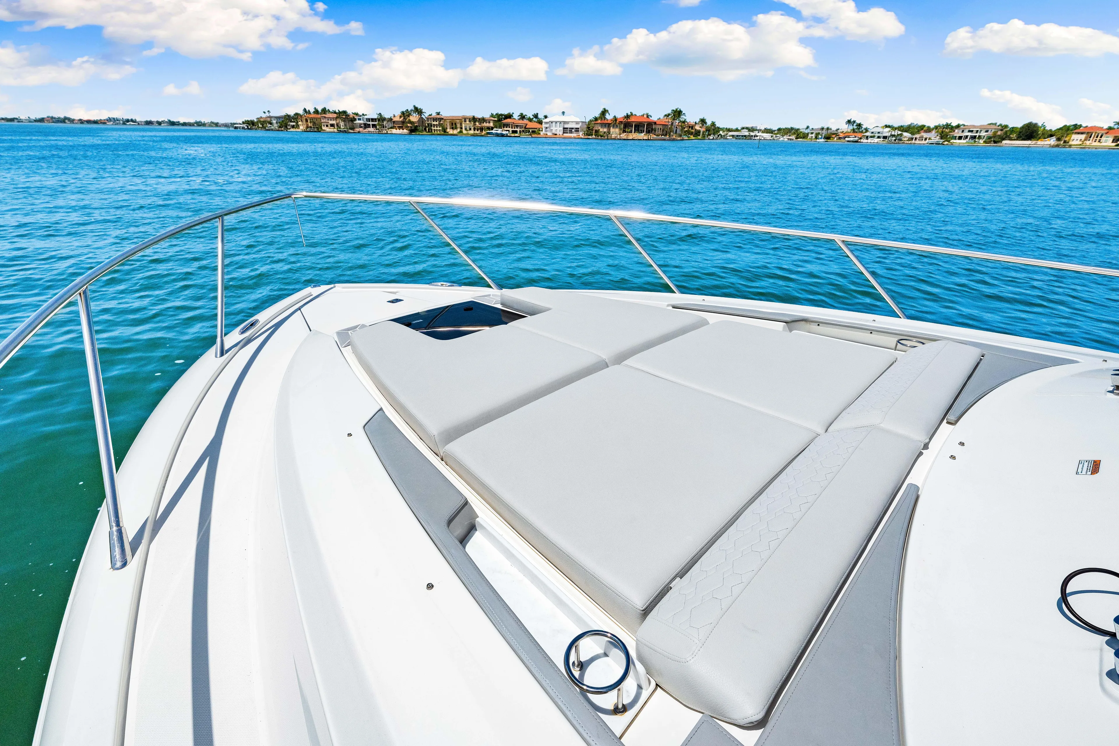  Yacht Photos Pics 2022 Tiara Yachts 43 LE boat with sunpad, cruising on clear blue water.