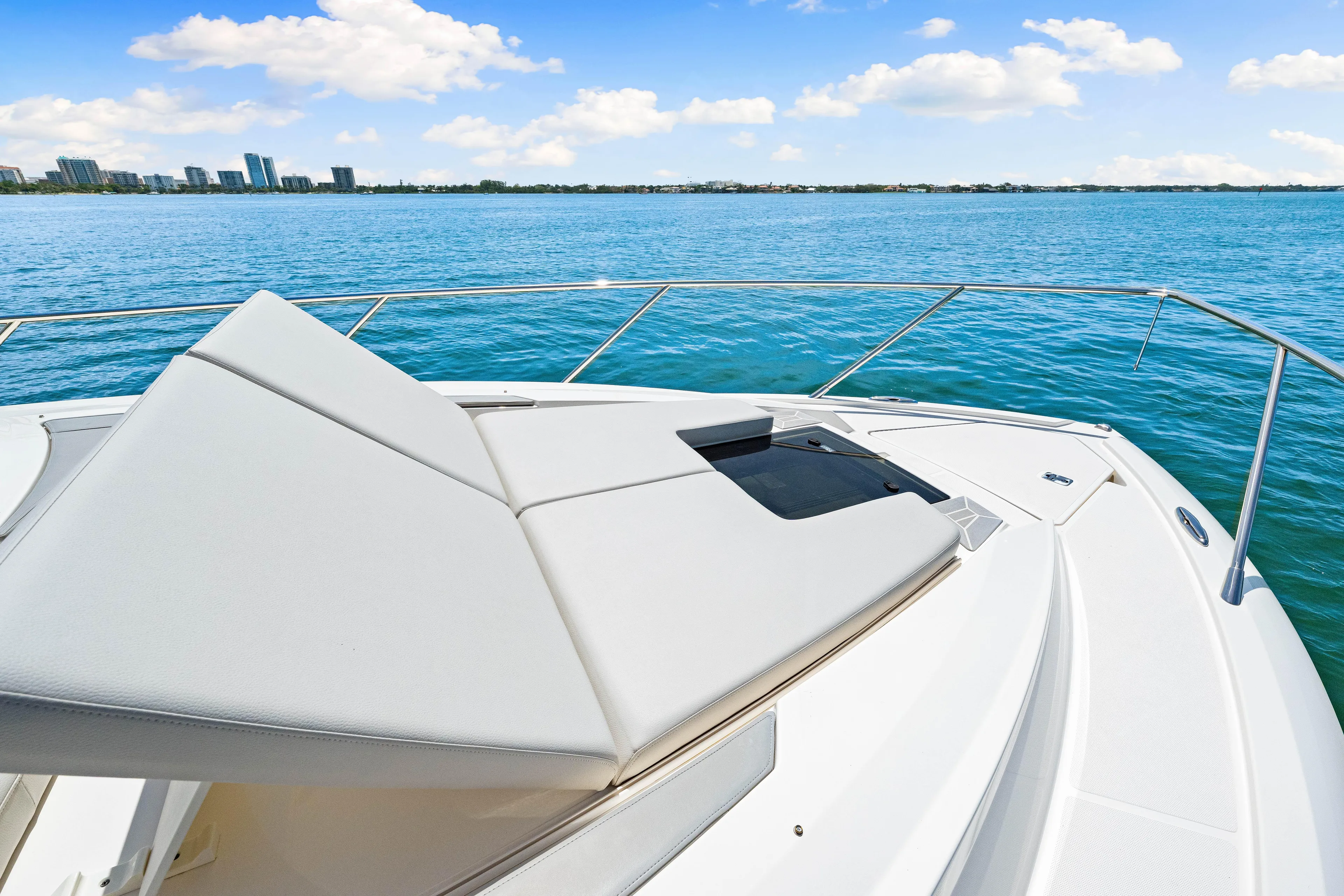  Yacht Photos Pics 2022 Tiara Yachts 43 LE on calm blue water with city skyline.