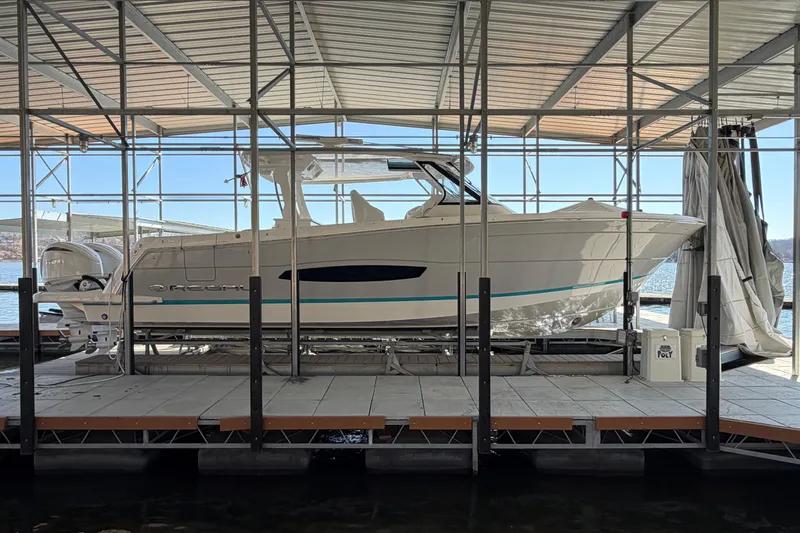  Yacht Photos Pics 2023 Regal 38 SAV boat docked under a covered marina.