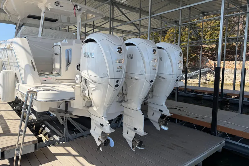  Yacht Photos Pics 2023 Regal 38 SAV boat with triple Yamaha outboard engines docked.