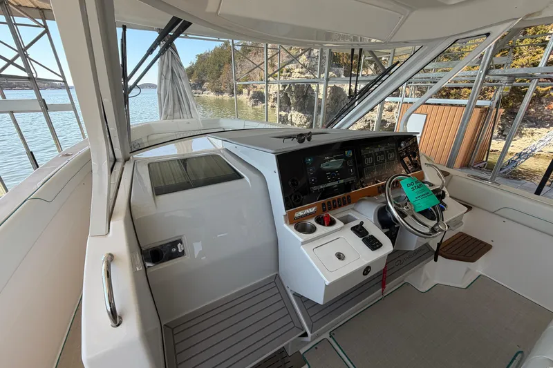  Yacht Photos Pics 2023 Regal 38 SAV boat cockpit with modern controls and scenic water view.