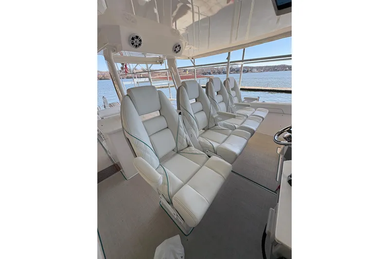  Yacht Photos Pics Luxurious seating inside 2023 Regal 38 SAV boat with waterfront view.
