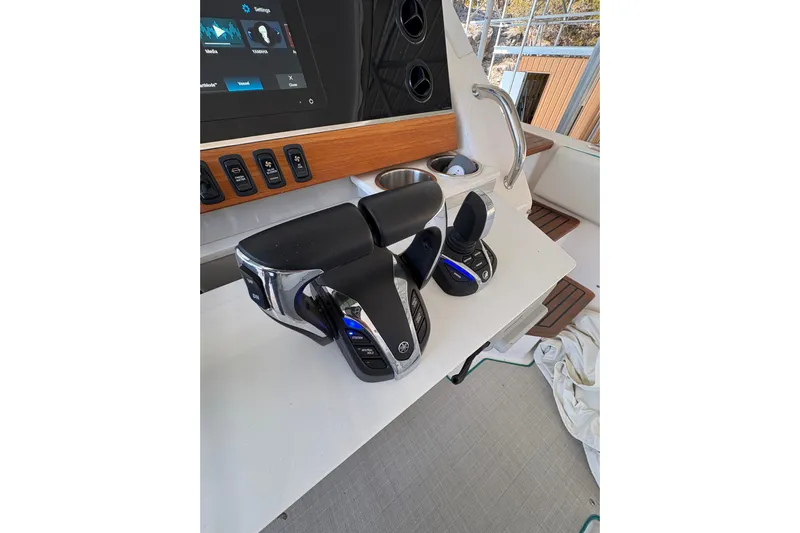  Yacht Photos Pics Control panel of 2023 Regal 38 SAV boat with modern throttle levers.