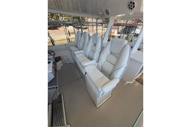  Yacht Photos Pics Luxurious seating on 2023 Regal 38 SAV boat, featuring plush white leather chairs.