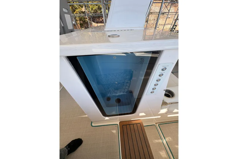  Yacht Photos Pics 2023 Regal 38 SAV boat interior with control panel and storage compartment.