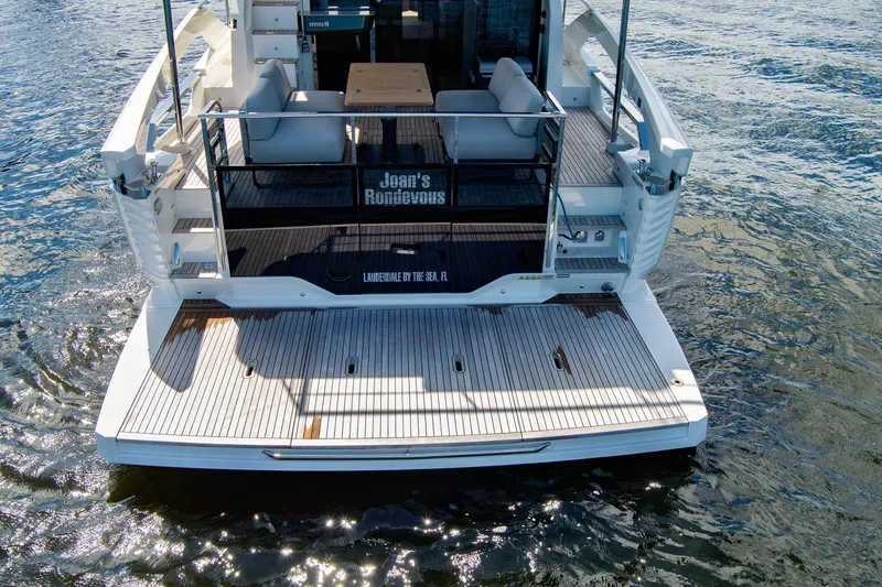 Joan's Rondevous Yacht Photos Pics 2025 Absolute 52 FLY yacht rear view with spacious deck and seating area.