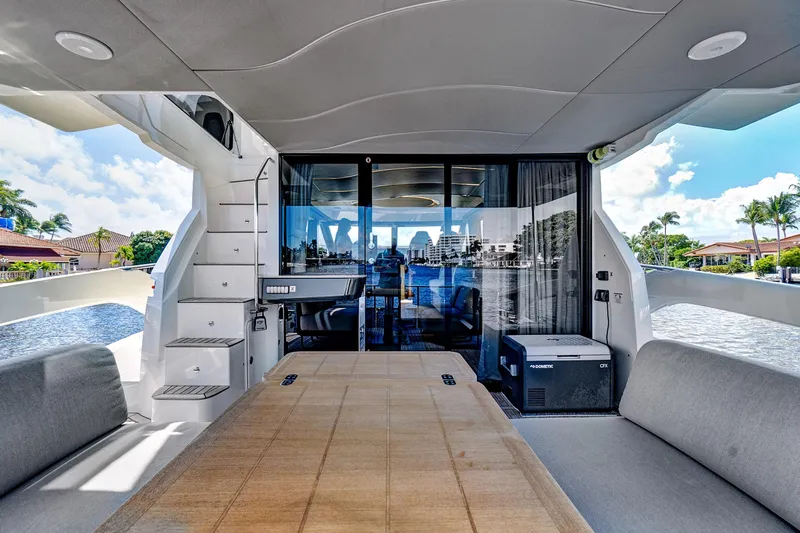 Joan's Rondevous Yacht Photos Pics Luxurious 2025 Absolute 52 FLY yacht interior with spacious seating and scenic water views.