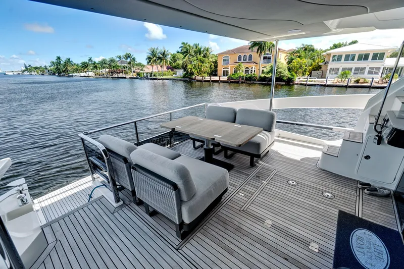 Joan's Rondevous Yacht Photos Pics Luxury deck of 2025 Absolute 52 FLY yacht with waterfront view.