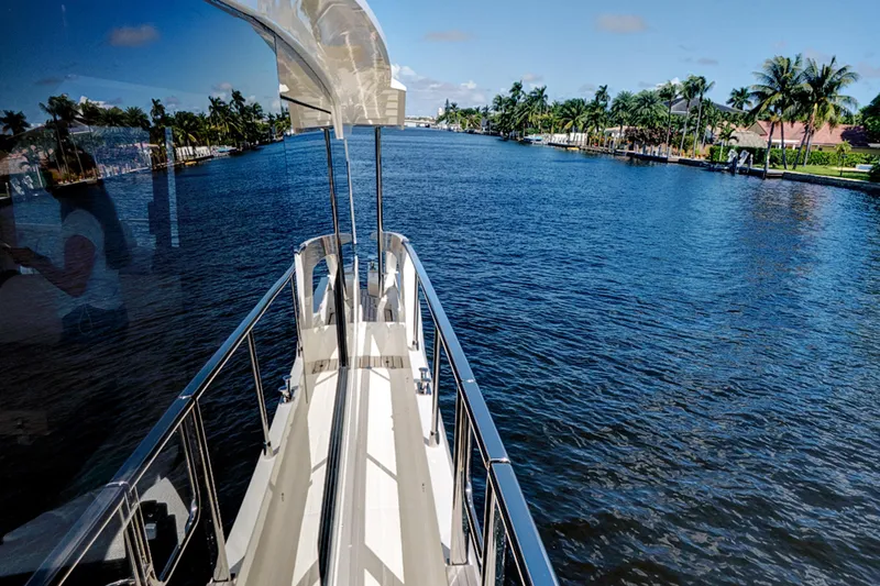 Joan's Rondevous Yacht Photos Pics Luxury yacht Absolute 52 FLY cruising on a scenic waterway, 2025 model.