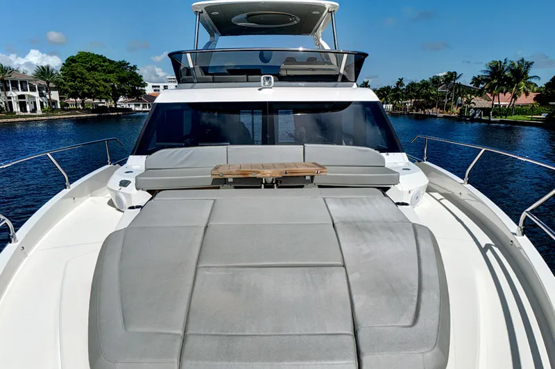 Joan's Rondevous Yacht Photos Pics 2025 Absolute 52 FLY yacht with spacious deck and luxurious seating on a sunny day.