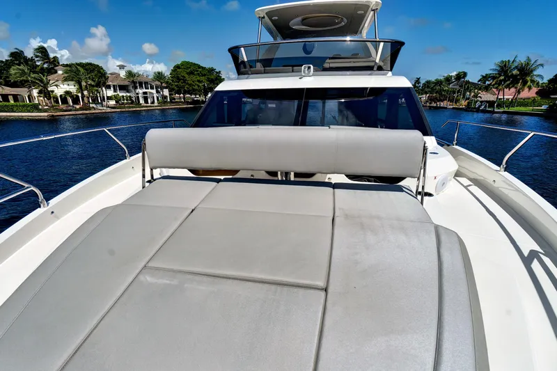 Joan's Rondevous Yacht Photos Pics Luxurious 2025 Absolute 52 FLY yacht with spacious sunbathing deck on serene waterway.