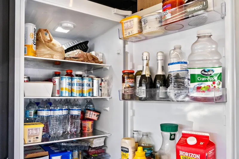 Joan's Rondevous Yacht Photos Pics Refrigerator stocked with beverages and food items on Absolute 52 FLY yacht, 2025 model.