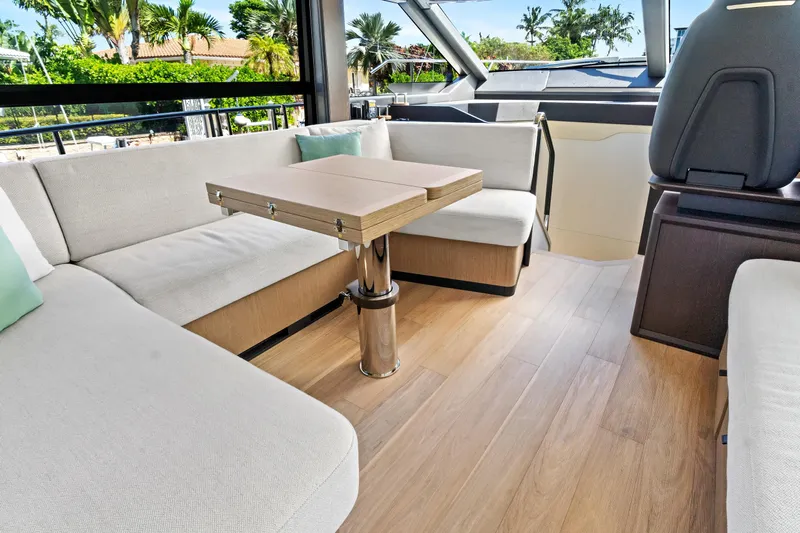 Joan's Rondevous Yacht Photos Pics Luxurious interior of 2025 Absolute 52 FLY yacht with elegant seating and table.
