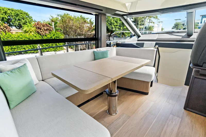 Joan's Rondevous Yacht Photos Pics Luxurious interior of 2025 Absolute 52 FLY yacht with elegant seating and table.