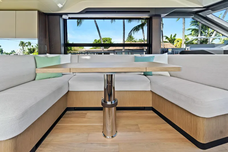 Joan's Rondevous Yacht Photos Pics Luxurious interior of 2025 Absolute 52 FLY yacht with elegant seating and table.